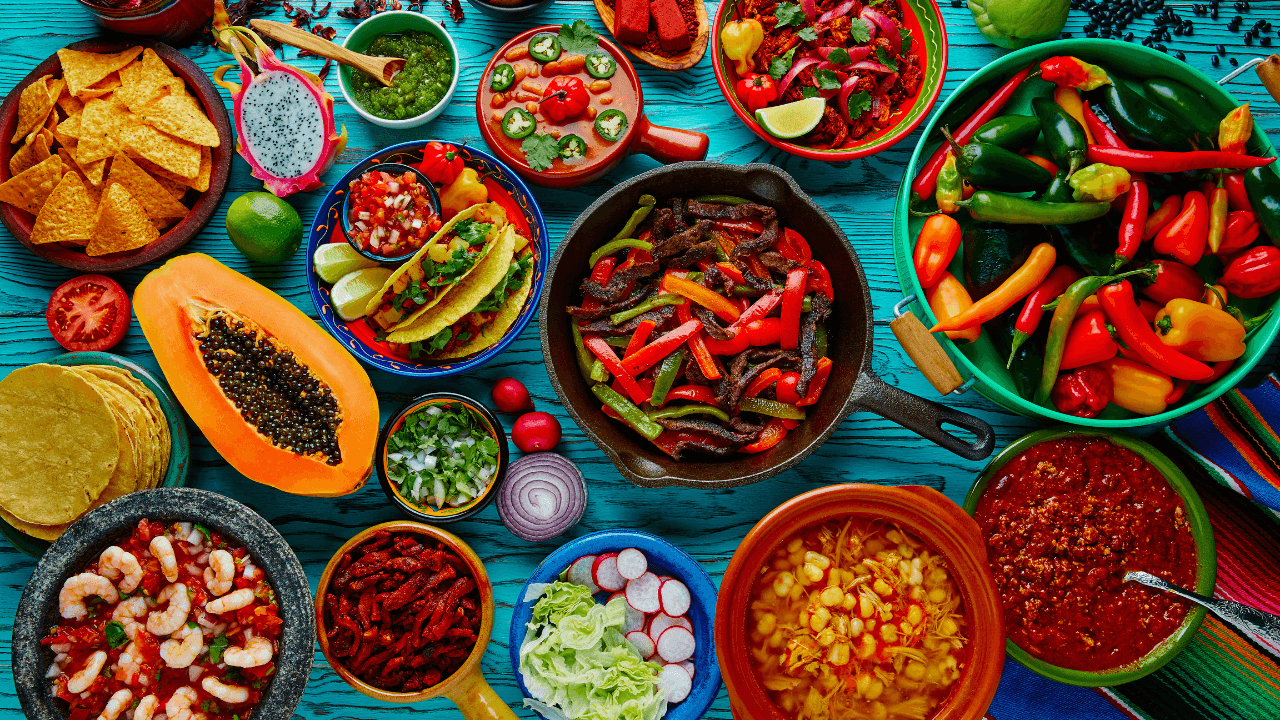 A vibrant table showcasing a variety of Mexican delicacies, bursting with colors and flavors.