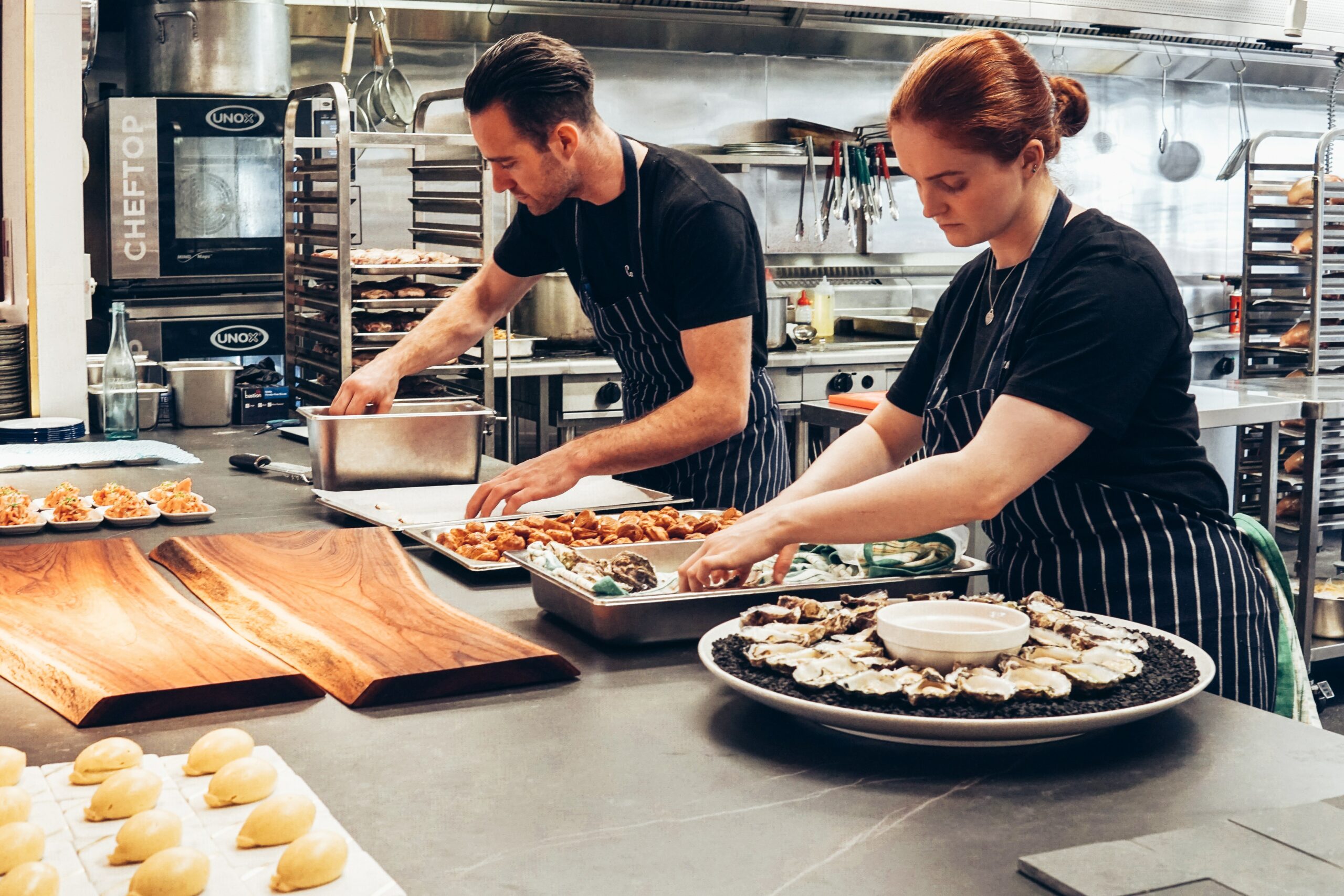 Two cooks are working in the restaurant kitchen.