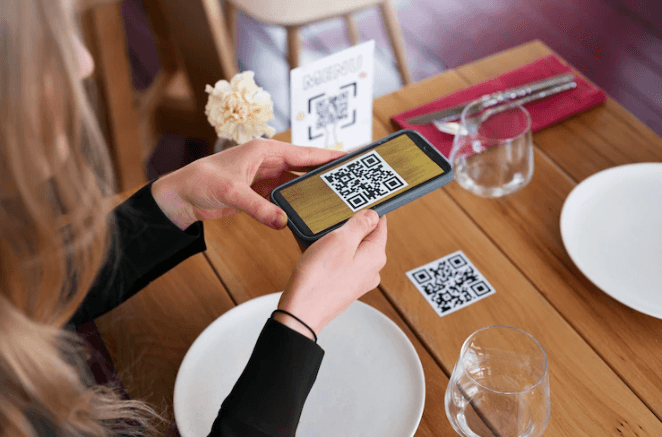 A girl is scanning a restaurant QR code for an online menu.