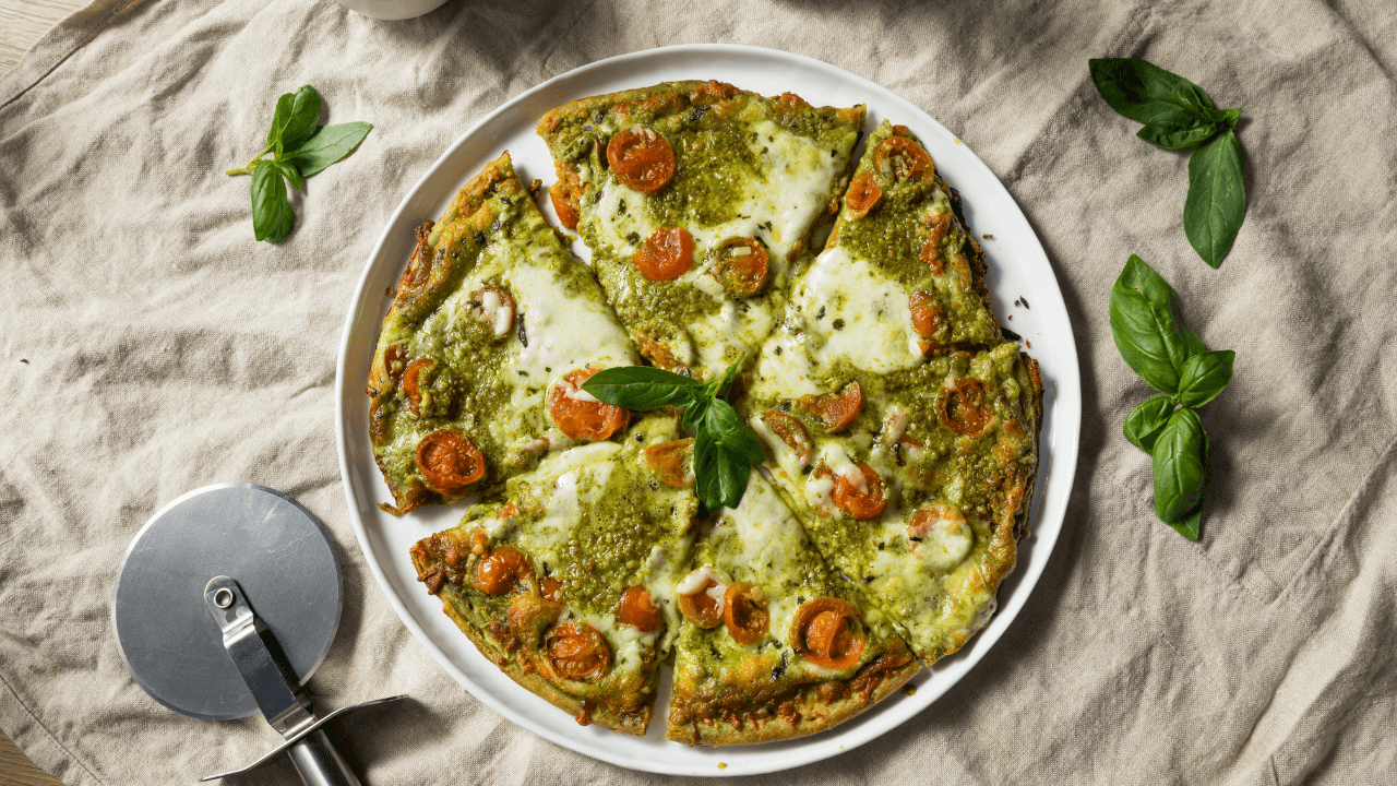 A pizza with pesto souse.