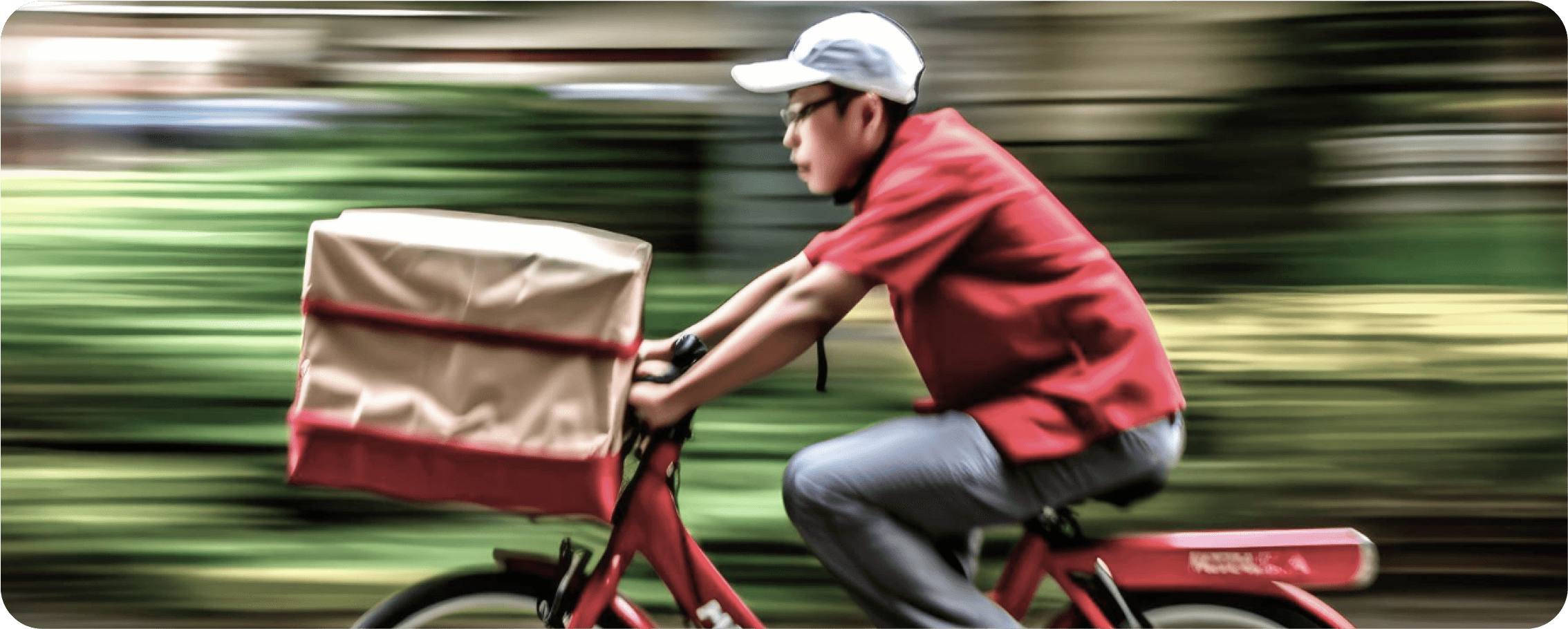 A delivery guy is rushing to deliver an order with his bicycle.