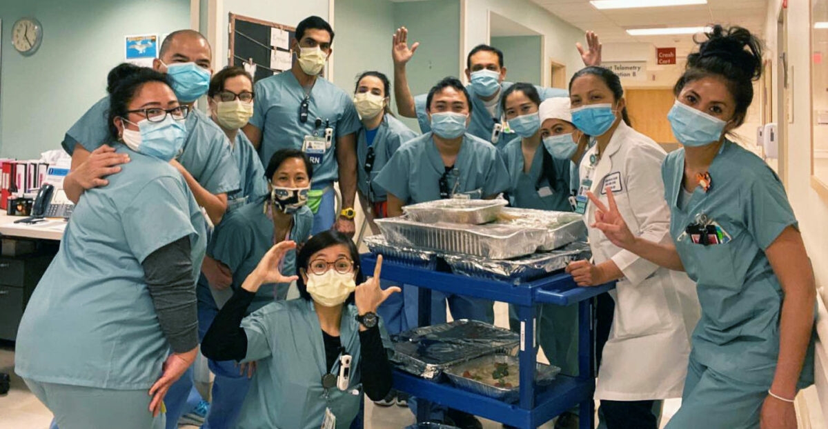Doctors with masks pose for a picture.